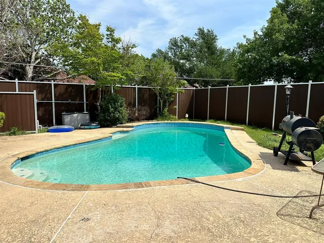 a view of a backyard with a sitting area