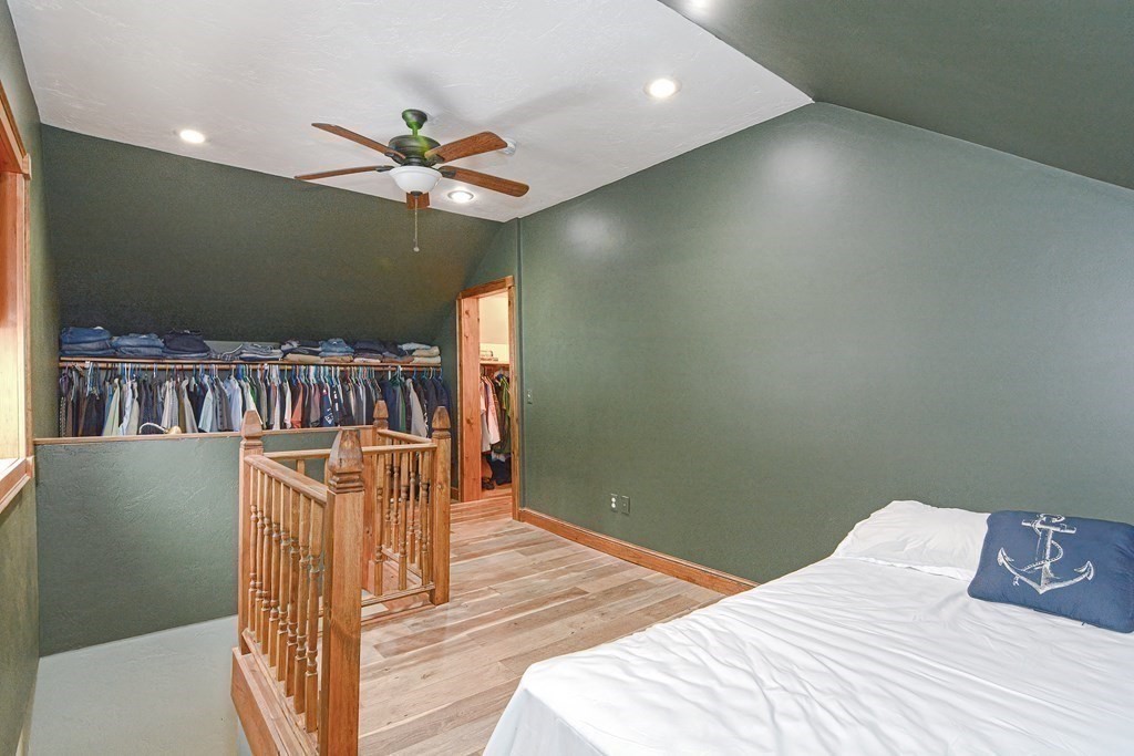 32 Allen Road Brookfield, MA 01506 - Photo 12 of 40 a bedroom with a bed and a bookshelf with wooden floor