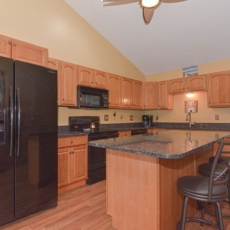 32 Allen Road Brookfield, MA 01506 - Photo 7 of 40 a kitchen with stainless steel appliances granite countertop a stove a sink dishwasher a microwave oven and a refrigerator with wooden floor