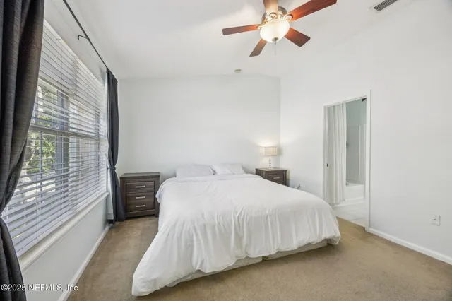 a bedroom with a bed and window