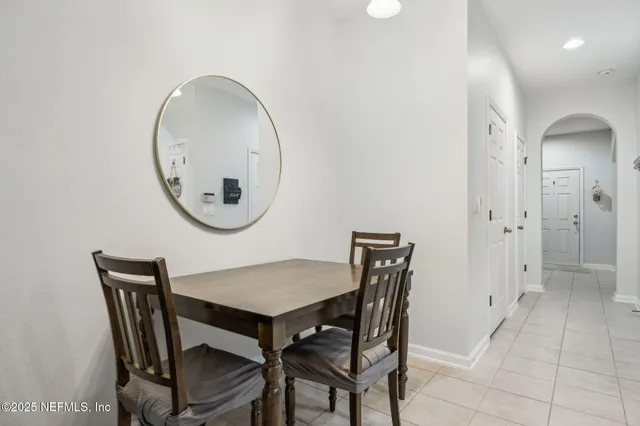 a view of a dining room with furniture and a mirror