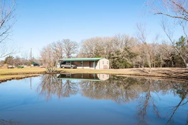 a view of a lake with houses in the background
