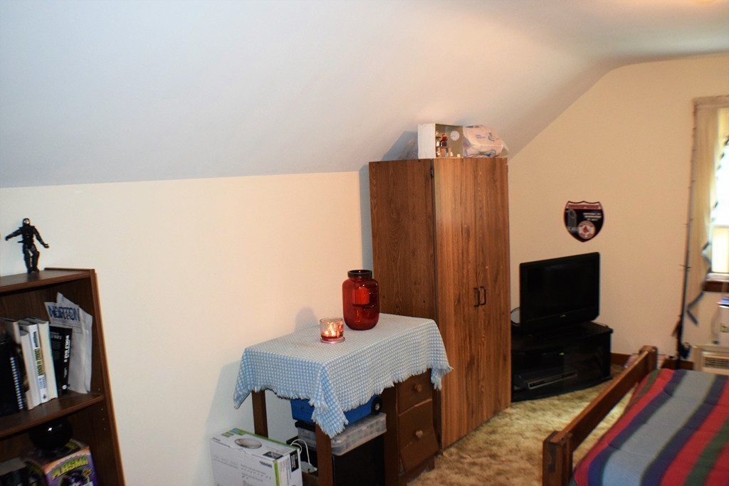 267 Wheelwright Road Barre, MA 01005 - Photo 21 of 29 a bedroom with a bed and a flat tv screen on the dresser