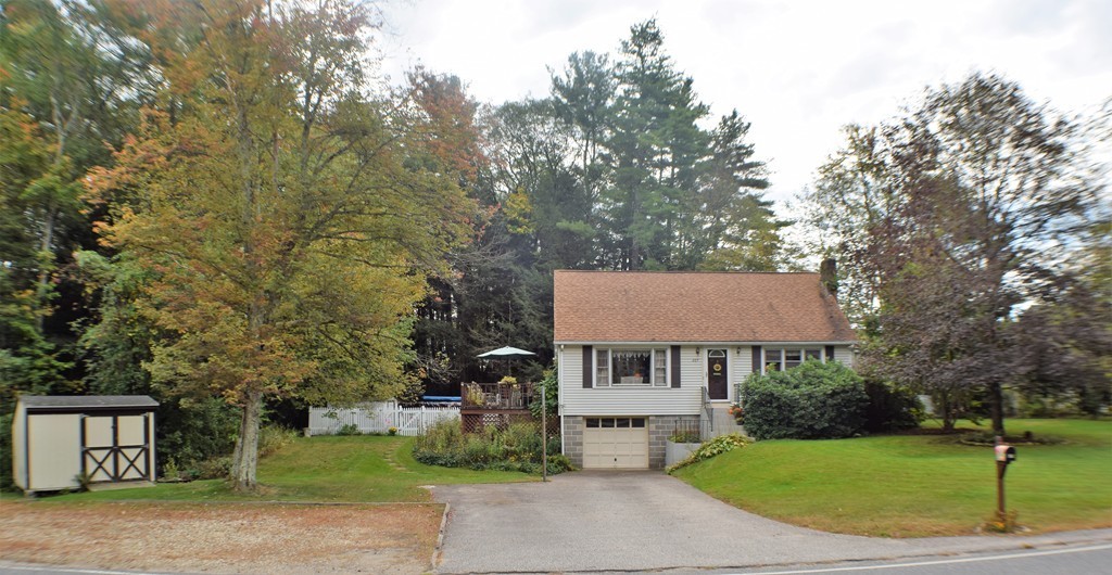 267 Wheelwright Road Barre, MA 01005 - Photo 28 of 29 a view of a white house with a yard and large tree