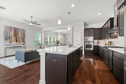 a kitchen with stainless steel appliances granite countertop a stove and cabinets