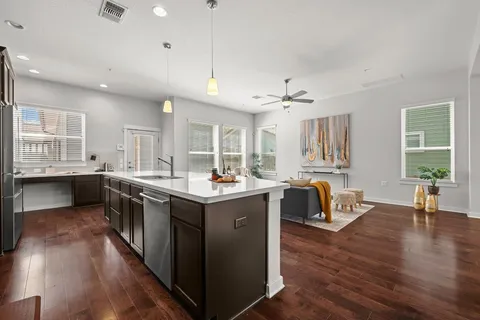 a large kitchen with kitchen island a counter top space a sink a appliances and cabinets