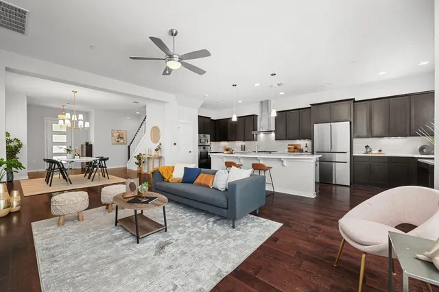 a living room with furniture and kitchen view