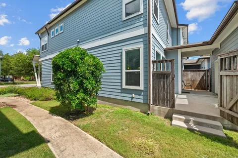 a backyard of a house with plants and garden