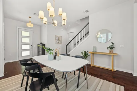 a view of a dining room with furniture and a chandelier