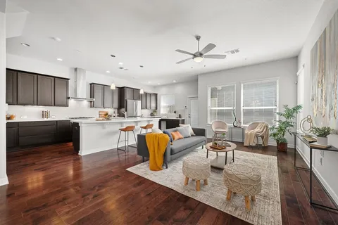 a living room with kitchen island furniture and a kitchen view
