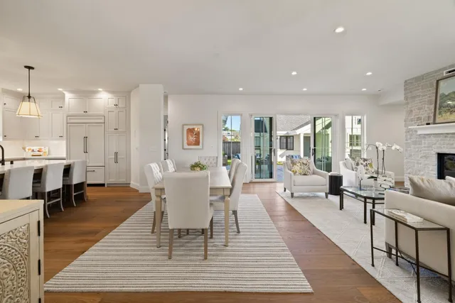 a dining room with wooden floor and white walls