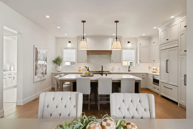 a kitchen with cabinets a sink appliances and living room view
