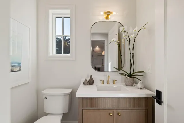 a bathroom with a sink toilet and mirror
