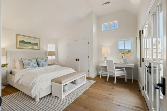 a spacious bedroom with a bed and a table
