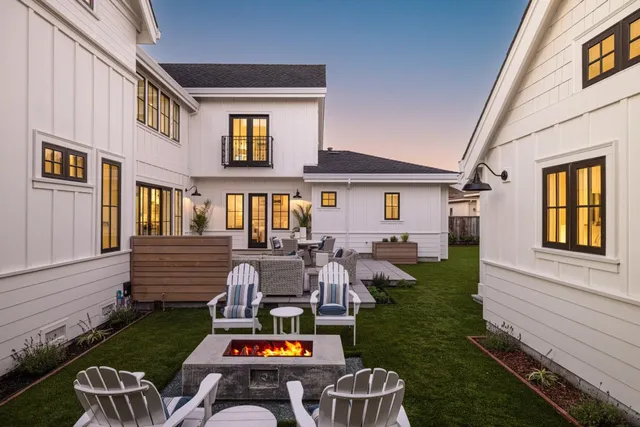 a view of a house with backyard porch and sitting area