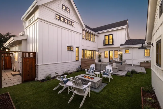 a backyard of a house with table and chairs
