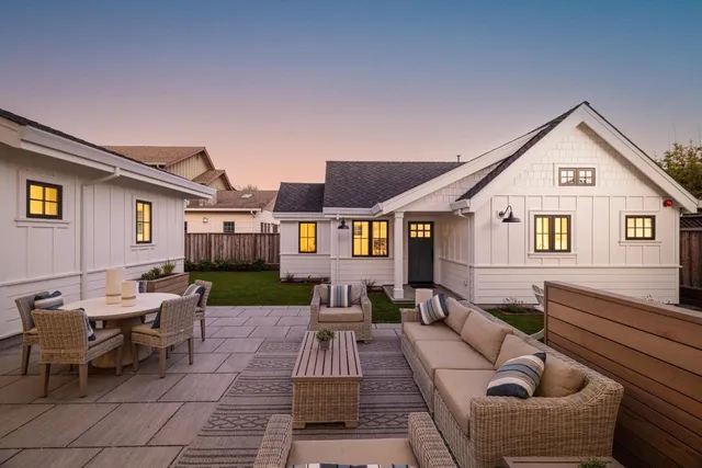 a view of a house with couches and a table