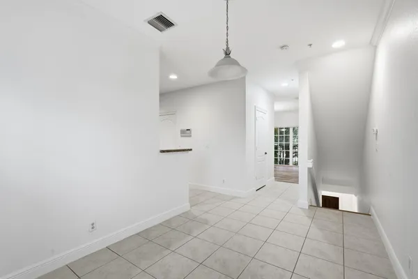 a view of a big room with wooden floor and windows