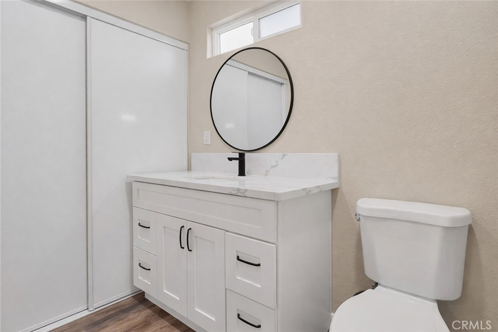 14695 Ocotilla Road Apple Valley, CA 92307 - Photo 13 of 16 a bathroom with a toilet a sink and a mirror