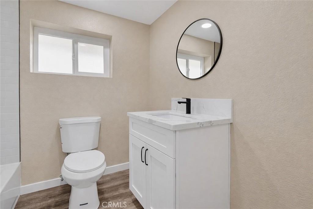 14695 Ocotilla Road Apple Valley, CA 92307 - Photo 14 of 16 a bathroom with a toilet sink and mirror