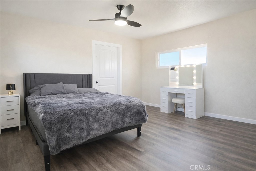 14695 Ocotilla Road Apple Valley, CA 92307 - Photo 16 of 16 a bedroom with a bed and a chandelier