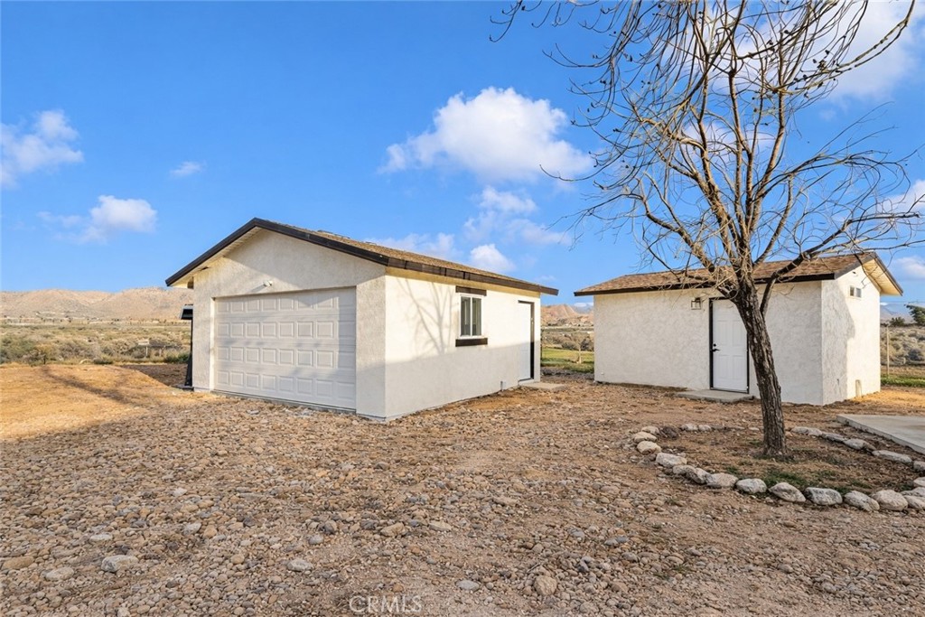 14695 Ocotilla Road Apple Valley, CA 92307 - Photo 2 of 16 a front view of a house with a yard and garage