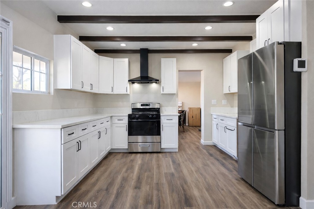 14695 Ocotilla Road Apple Valley, CA 92307 - Photo 4 of 16 a kitchen with stainless steel appliances a refrigerator stove and wooden cabinets