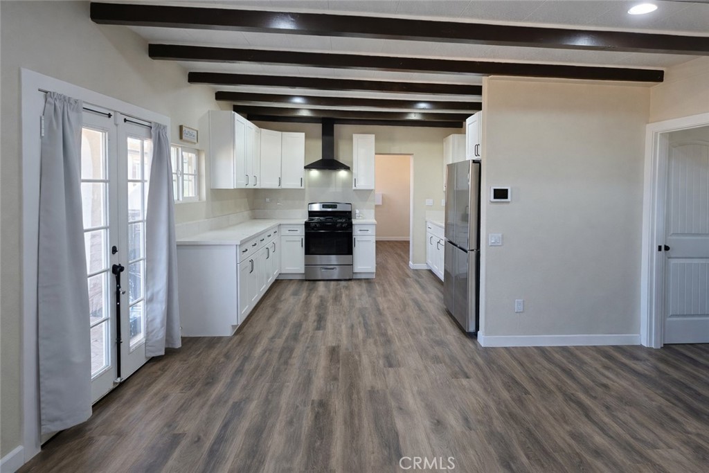 14695 Ocotilla Road Apple Valley, CA 92307 - Photo 5 of 16 a kitchen with a refrigerator a sink and wooden floor
