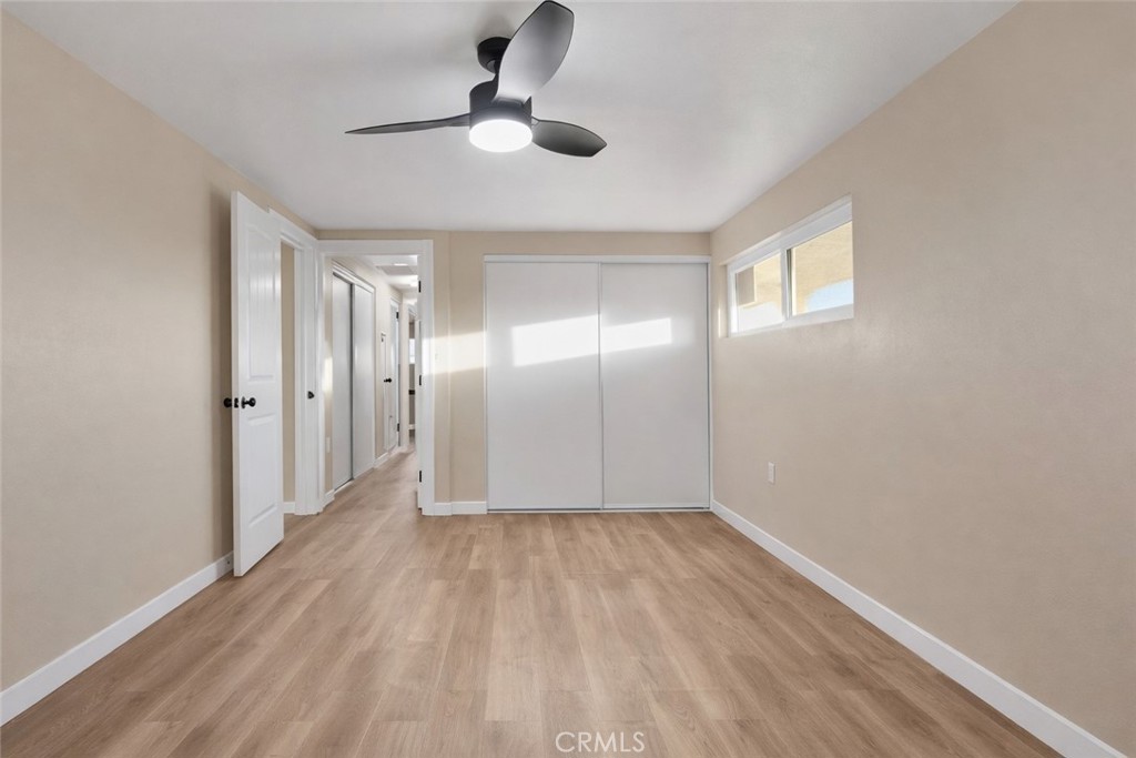 14695 Ocotilla Road Apple Valley, CA 92307 - Photo 9 of 16 wooden floor in an empty room with a window