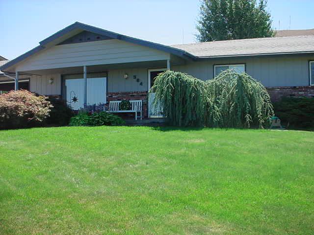 504 Meadowbrook Road Yakima, WA 98903 - Photo 1 of 18 a view of a yard in front of a house with plants and large tree