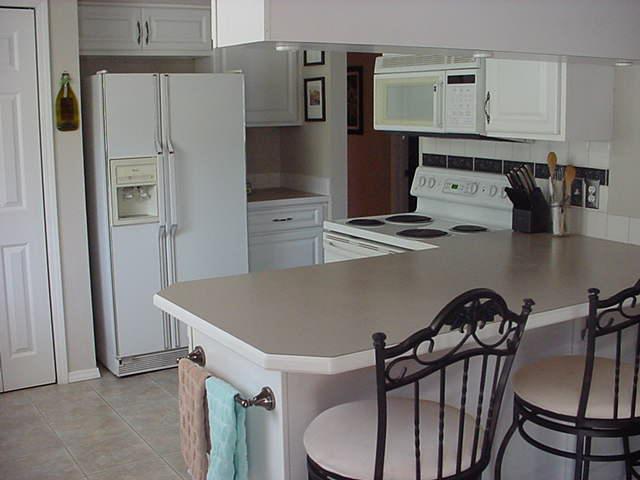 504 Meadowbrook Road Yakima, WA 98903 - Photo 12 of 18 a kitchen with stainless steel appliances a refrigerator and a stove