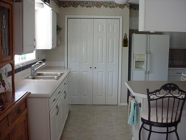504 Meadowbrook Road Yakima, WA 98903 - Photo 14 of 18 a kitchen with a sink appliances and cabinets