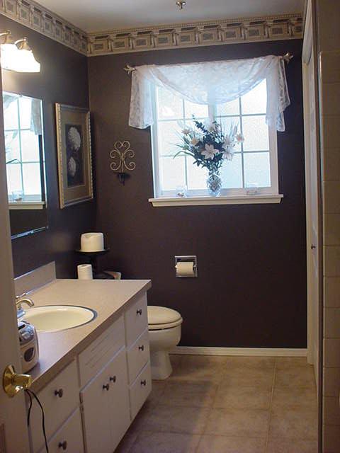 504 Meadowbrook Road Yakima, WA 98903 - Photo 7 of 18 a bathroom with a granite countertop toilet a sink and a window