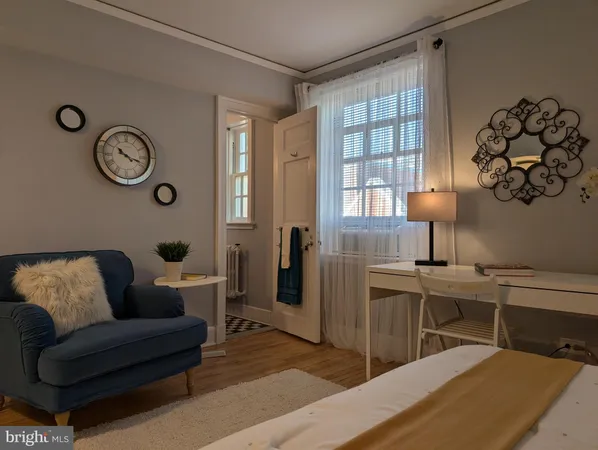 a living room with furniture wooden floor and window