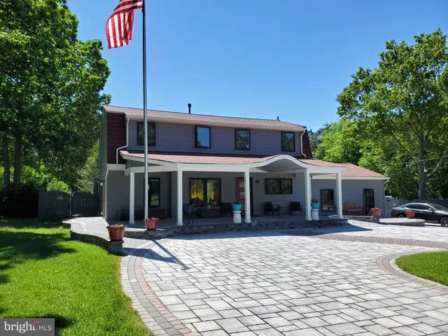 a view of a house with backyard porch and sitting area