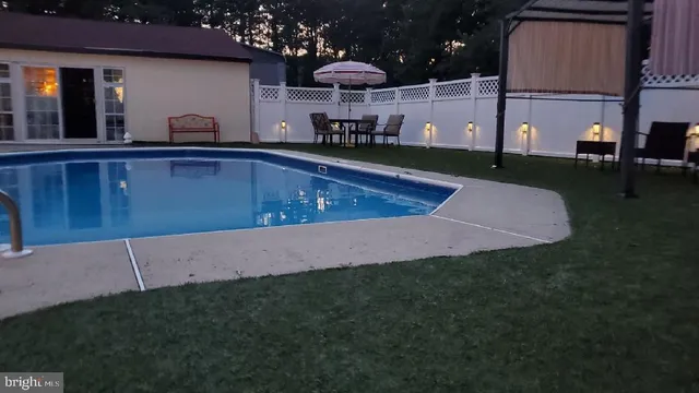 an aerial view of a house with a swimming pool