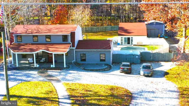 an aerial view of a house with garden space and patio