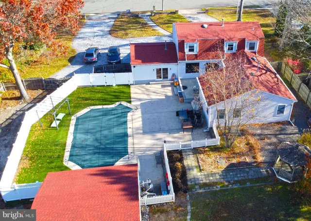 a aerial view of a house with a yard and large trees