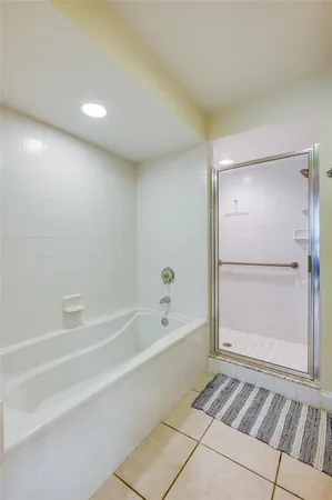 a bathroom with a bathtub and a shower