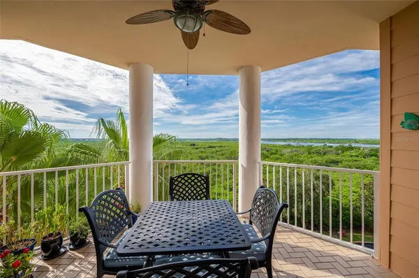 a view of a deck with a table chairs and a yard