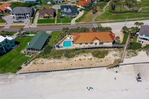 an aerial view of house with yard swimming pool and outdoor seating