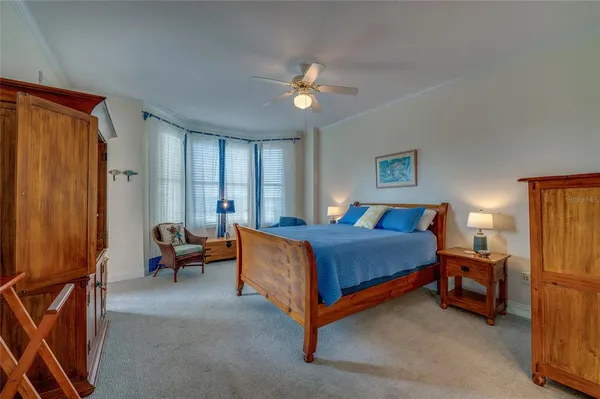 a bedroom with bed and a chandelier
