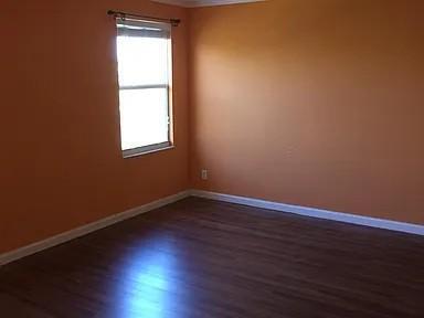 6397 Adriatic Way Greenacres, FL 33413 - Photo 15 of 29 an empty room with wooden floor and windows