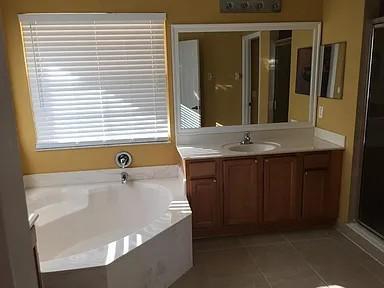 6397 Adriatic Way Greenacres, FL 33413 - Photo 16 of 29 a bathroom with a granite countertop sink and a mirror