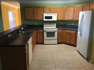 6397 Adriatic Way Greenacres, FL 33413 - Photo 2 of 29 a kitchen with granite countertop a refrigerator a stove a sink and dishwasher