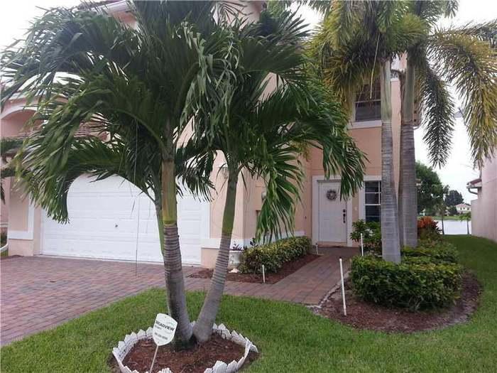 6397 Adriatic Way Greenacres, FL 33413 - Photo 23 of 29 a view of a backyard with palm trees