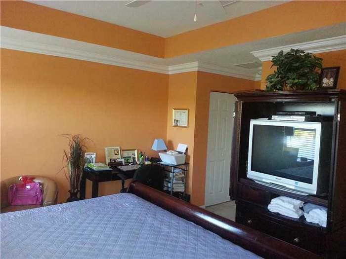 6397 Adriatic Way Greenacres, FL 33413 - Photo 26 of 29 a living room with furniture and a fireplace