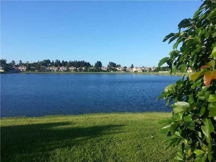 6397 Adriatic Way Greenacres, FL 33413 - Photo 28 of 29 a view of a lake with outdoor space