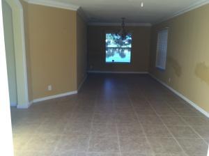 6397 Adriatic Way Greenacres, FL 33413 - Photo 6 of 29 an empty room with windows and chandelier