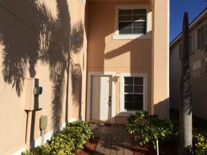 6397 Adriatic Way Greenacres, FL 33413 - Photo 8 of 29 a front view of a house with a garden